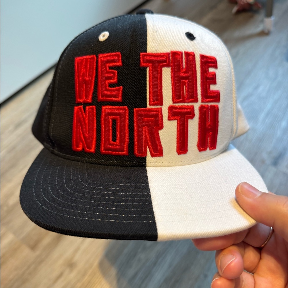 Mitchell & Ness We The North Black and White SnapBack Hat with Red Lettering